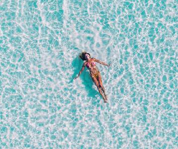 A woman relaxes in the ocean