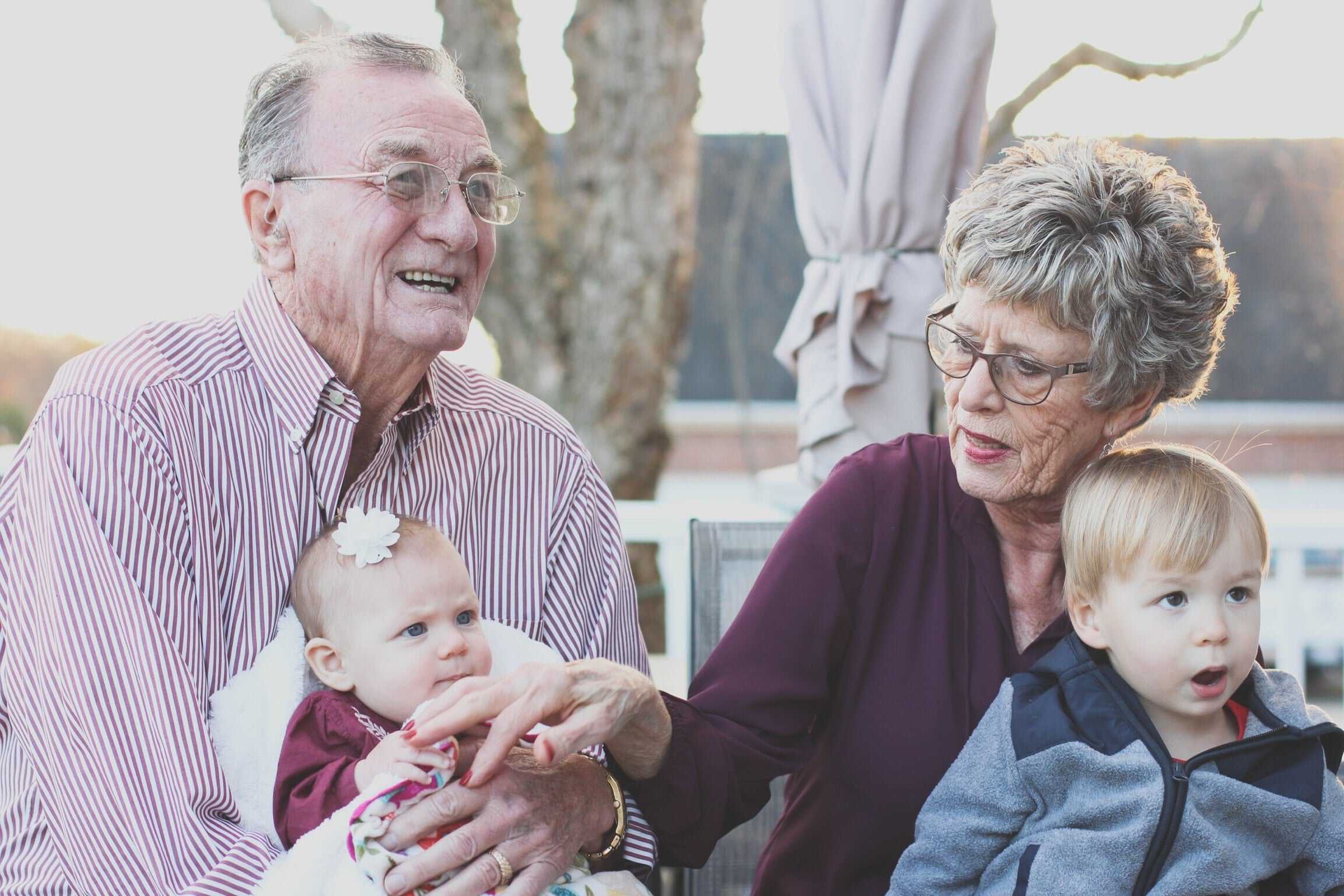 Grandparents hold their grandkids